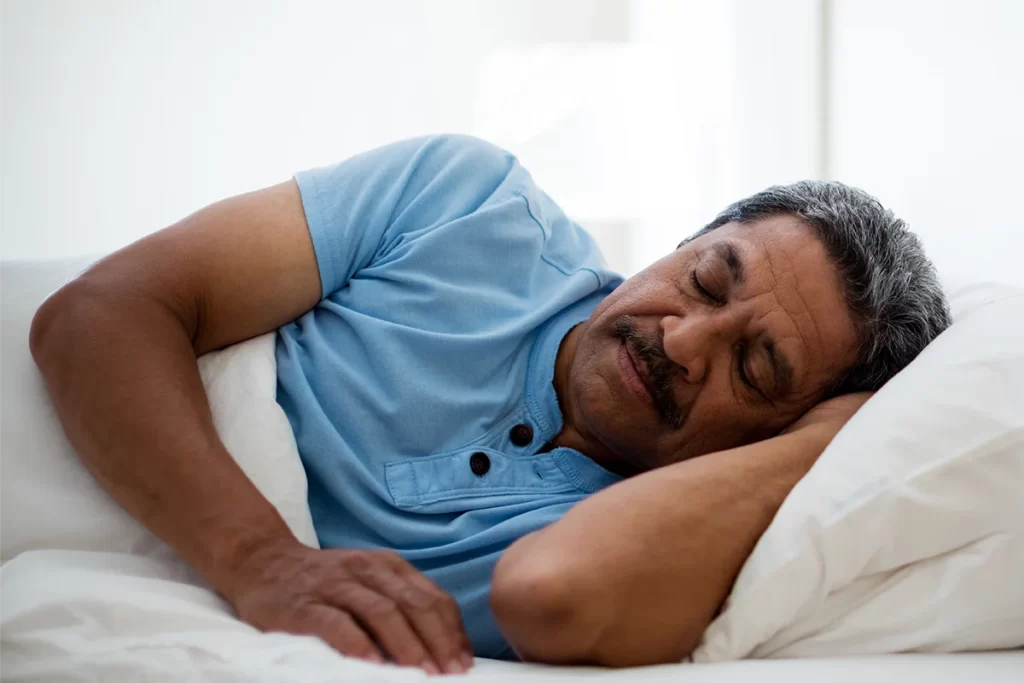 senior man sleeping in safe shelter environment