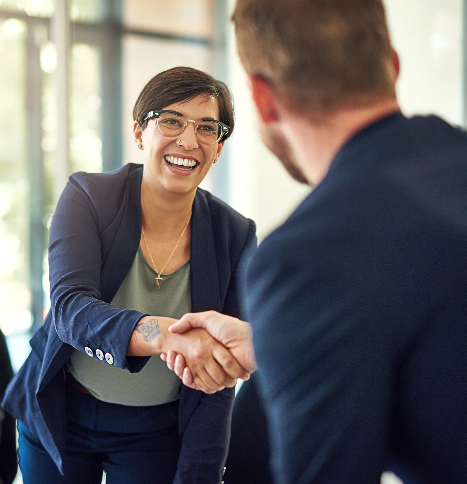 business woman shaking hand at corporate partnership meeting