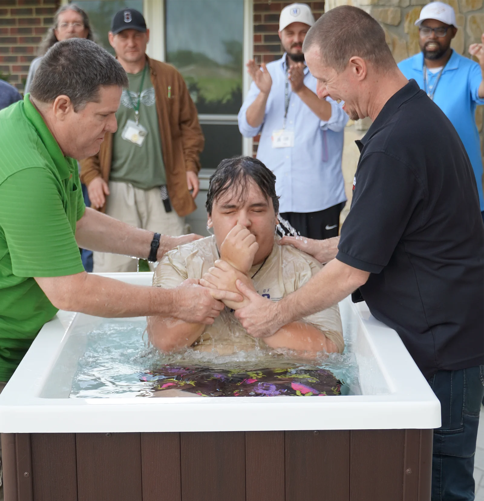 man at urm wichita getting baptized