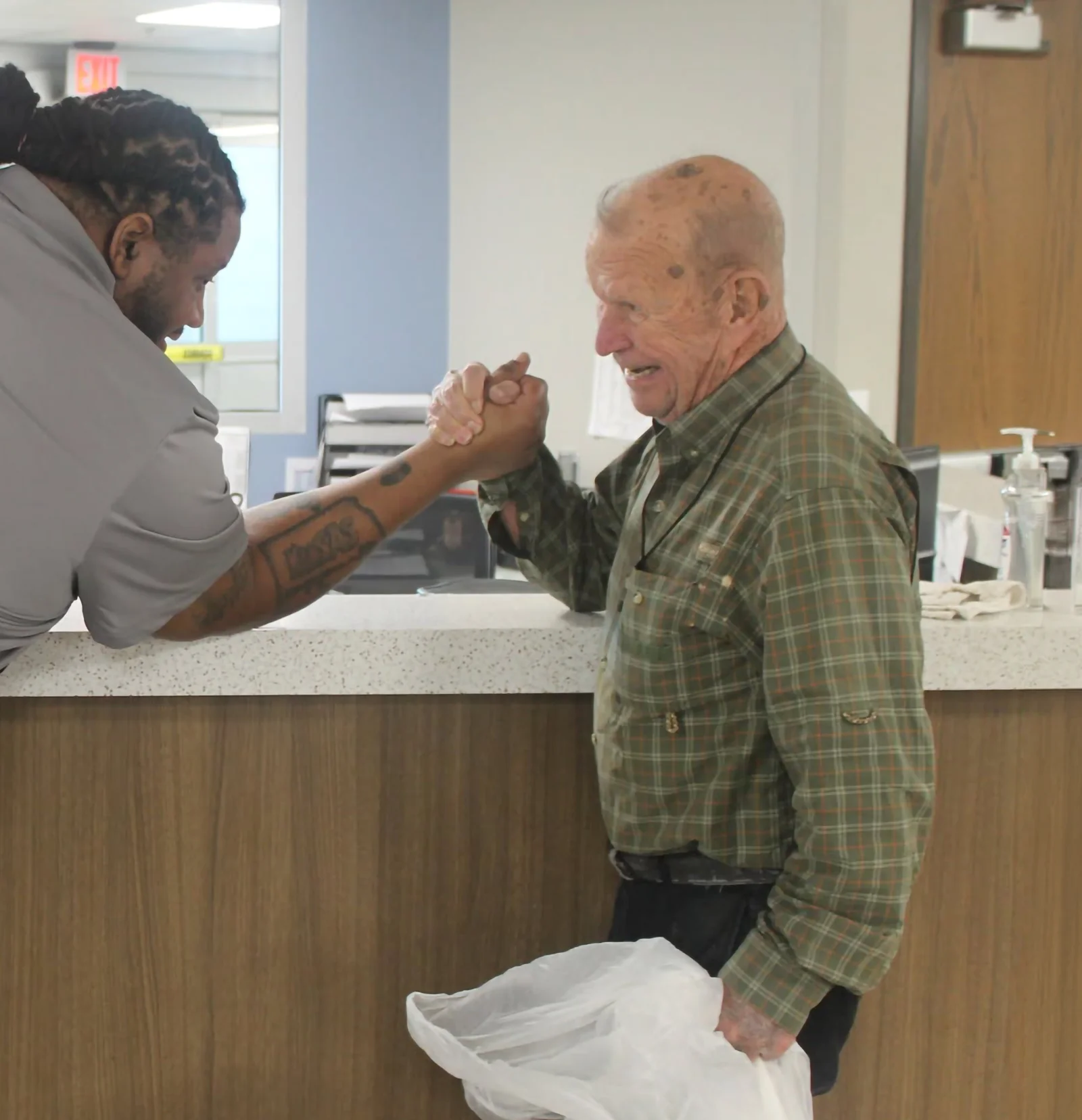 man receiving a supportive handshake at urm wichita