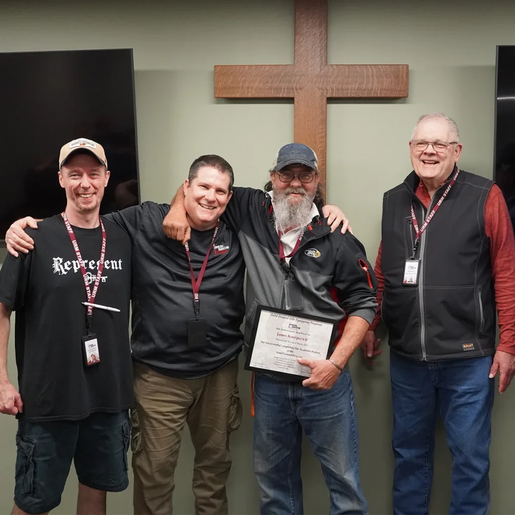 urm man with counselors and staff