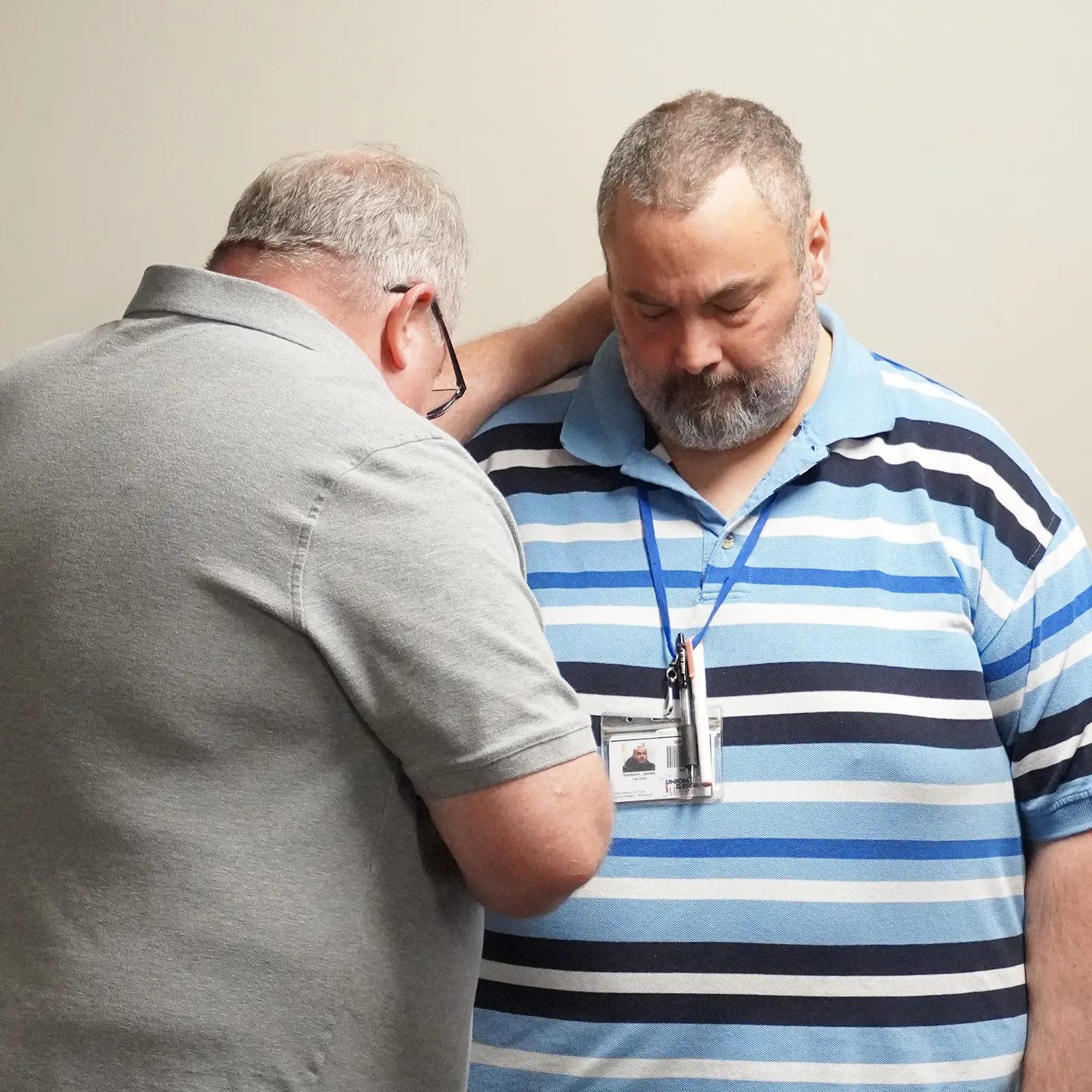 urm mentor praying over participant