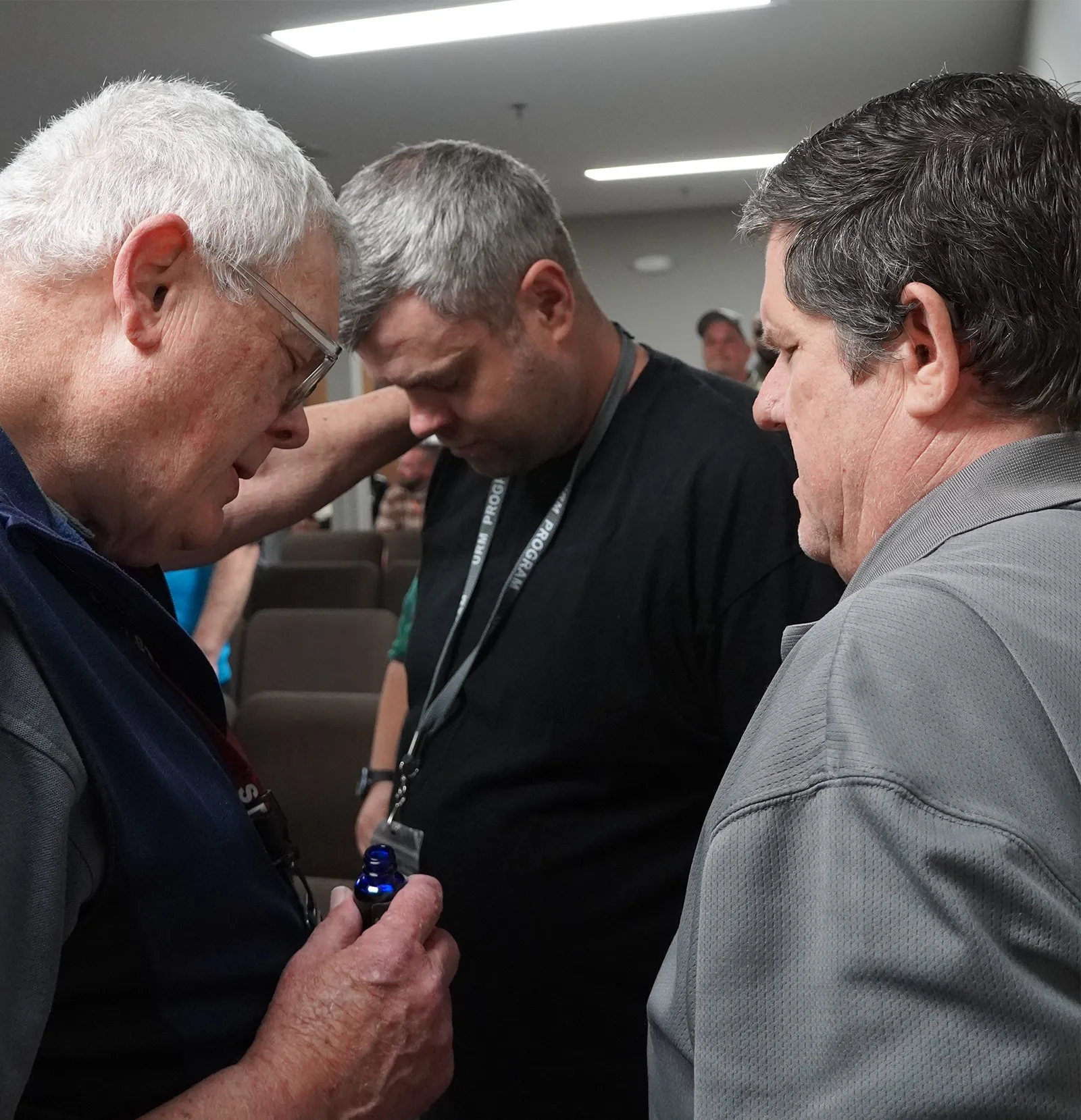 urm staff praying over member
