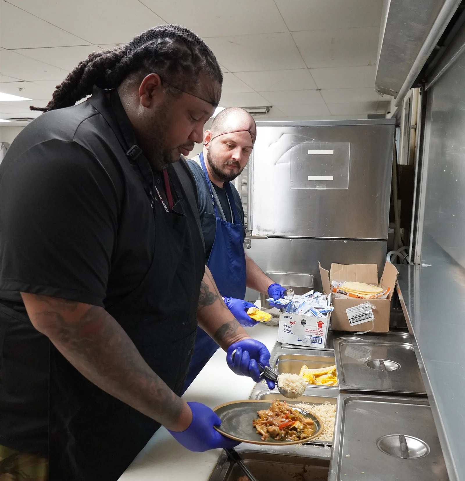 urm workers preparing warm meals for particpants